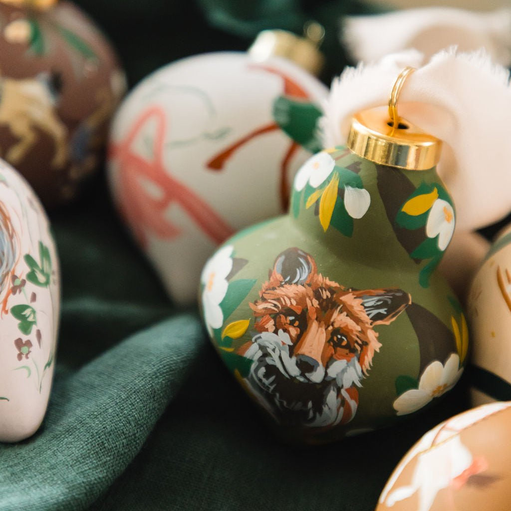 Decorative ornaments with animal designs on a green fabric background