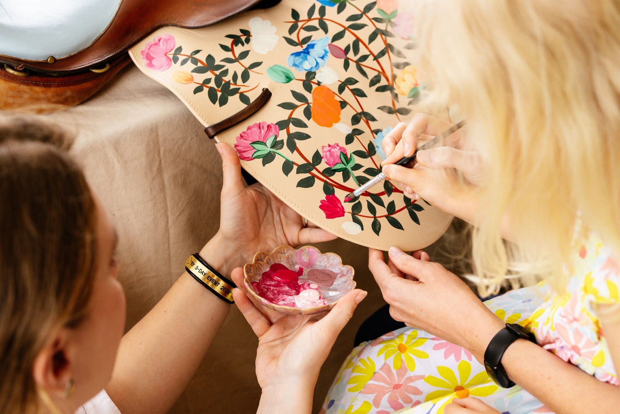 A visitor joins equestrian artist at a live painting event at Wellington International