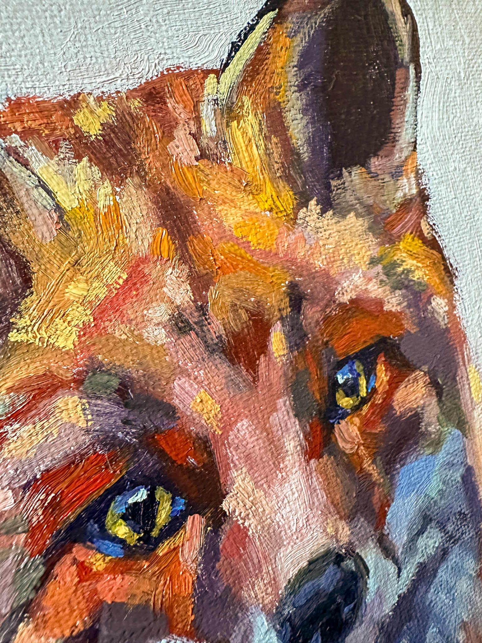 Close-up of a painting of a fox's face with detailed fur and expressive eyes.