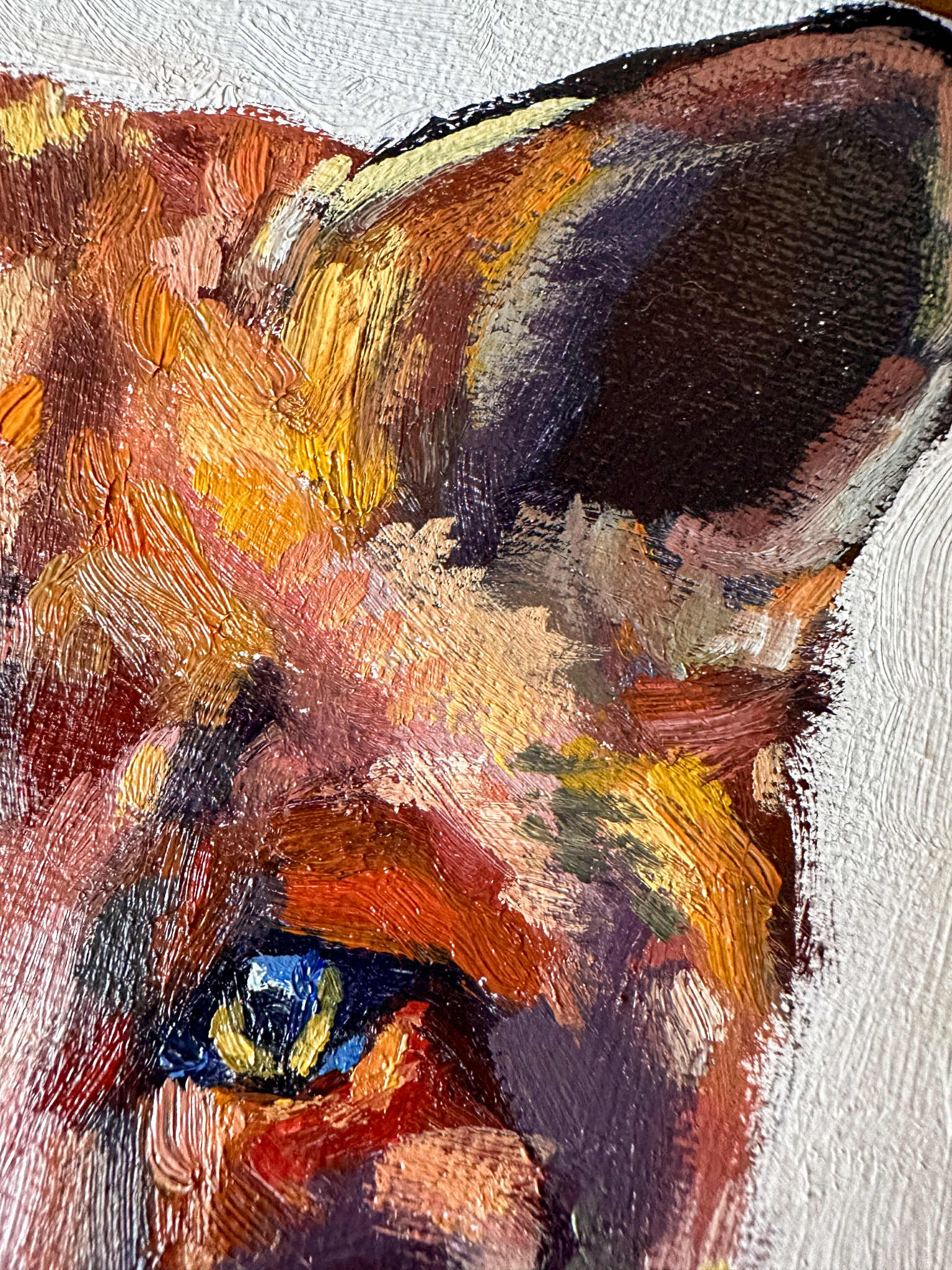 Close-up of a painting of a fox's face with a focus on the eye.