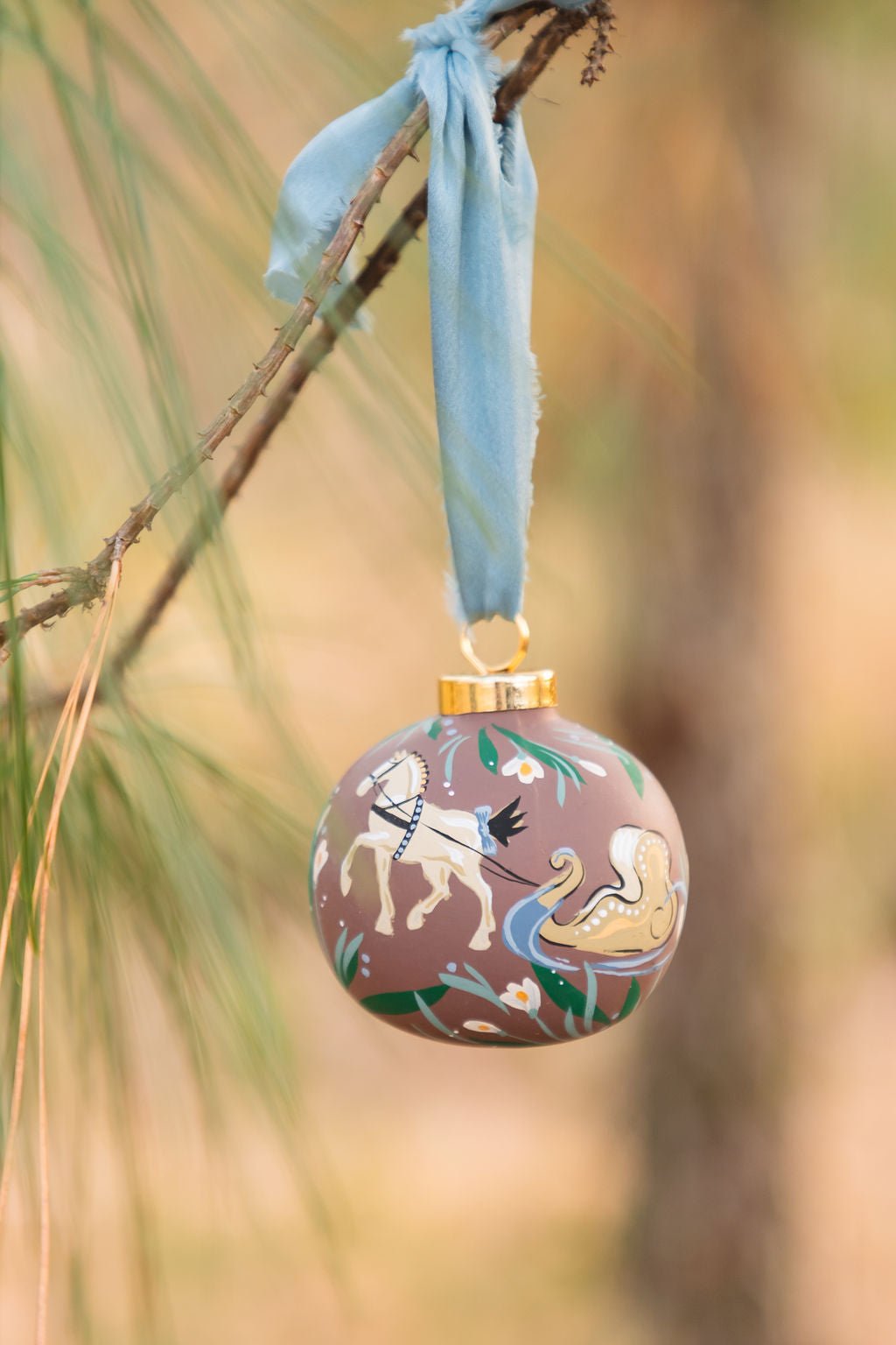 Decorative Christmas ornament with sleigh horse on a branch