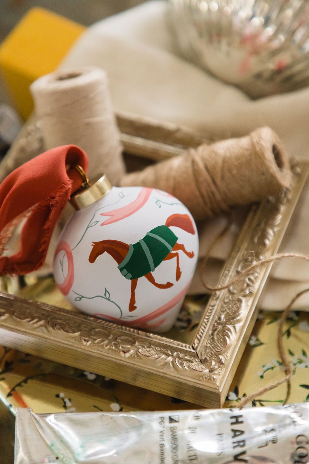 Decorative ornament with horse design on a gold frame and textured surface