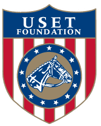 Logo of United States Equestrian Team USET Foundation with a shield design featuring a horse and American flag colors.
