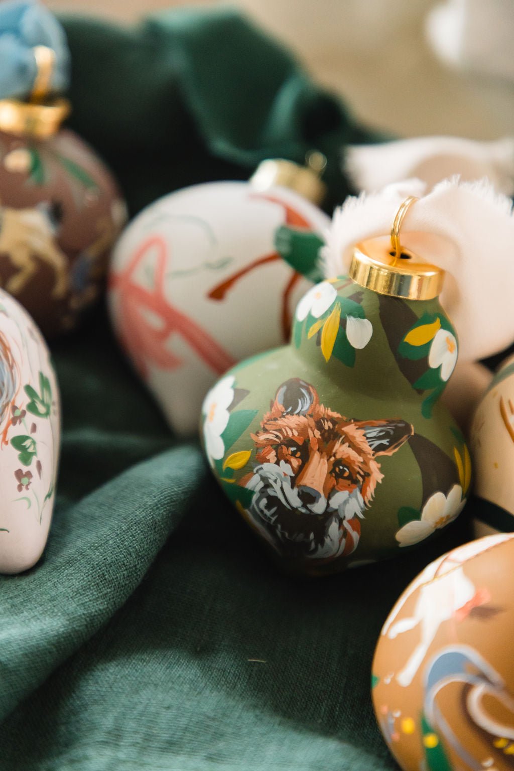 Decorative ornaments with animal designs on a green fabric background