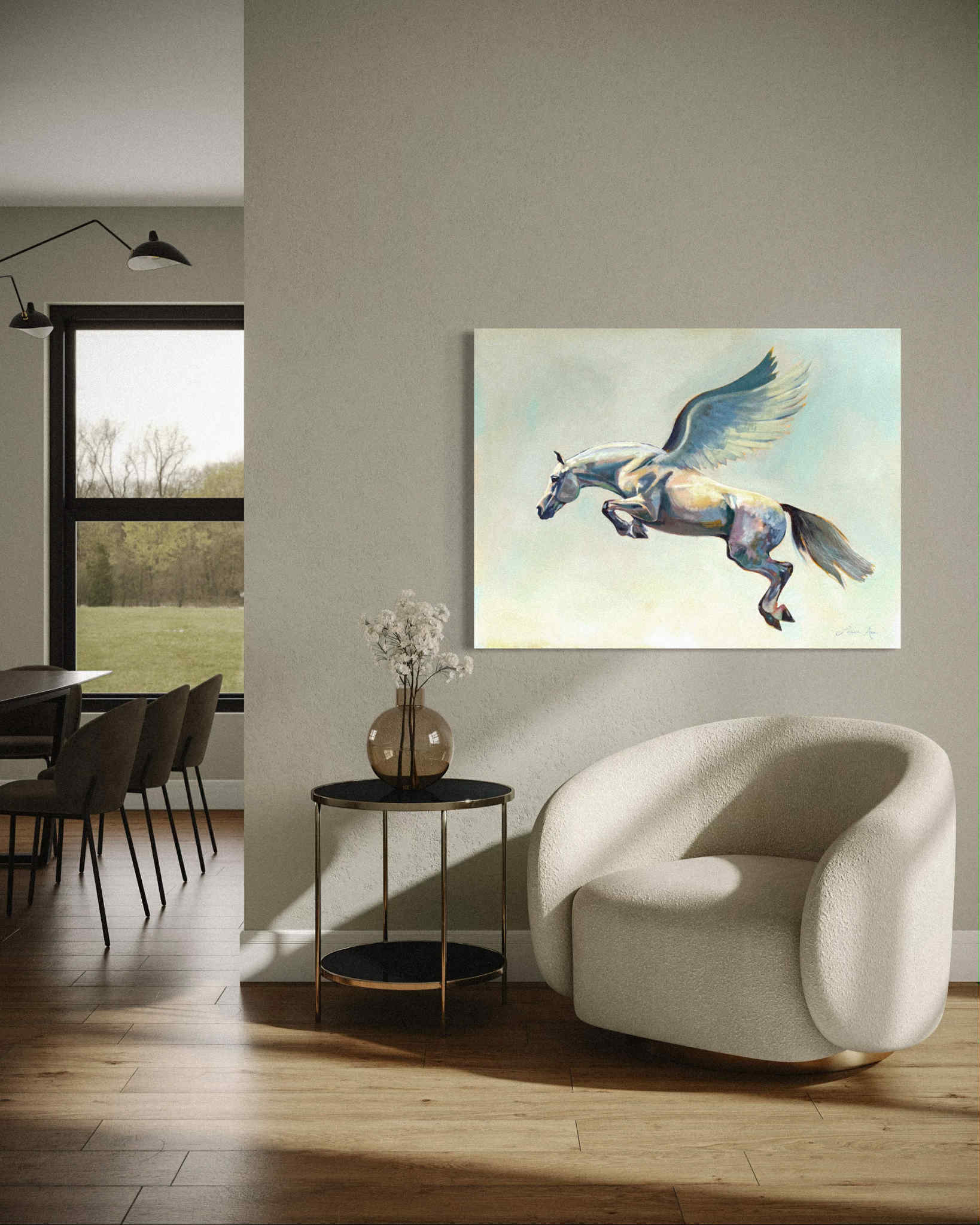 Living room with a white armchair, round table, and an original equestrian painting of a winged pegasus horse on the wall.